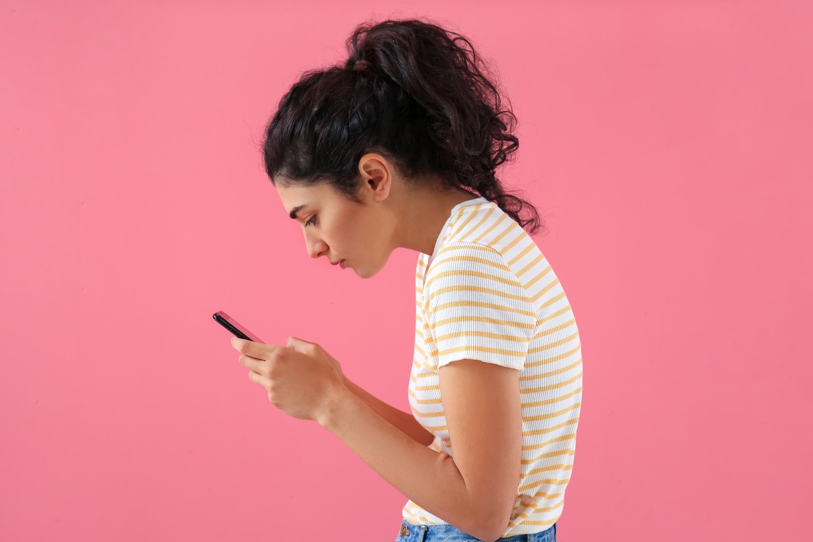 Young,Woman,With,Bad,Posture,Using,Mobile,Phone,On,Color